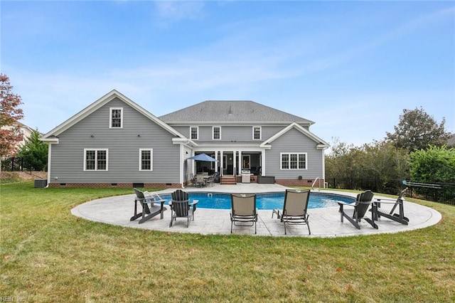 rear view of property with cooling unit, a lawn, a patio, and a fenced in pool