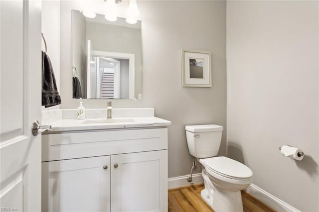 bathroom featuring hardwood / wood-style floors, vanity, and toilet