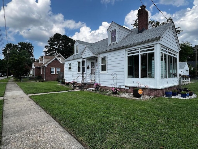 view of front of property with a front lawn and a sunroom