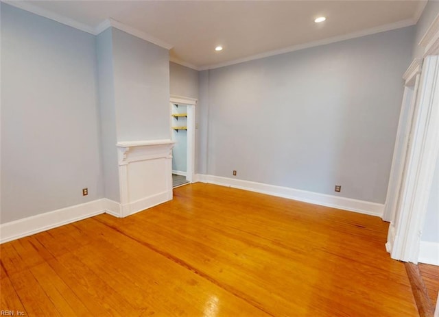 spare room featuring ornamental molding and wood-type flooring