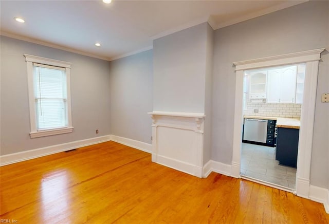 unfurnished room featuring wood-type flooring and ornamental molding