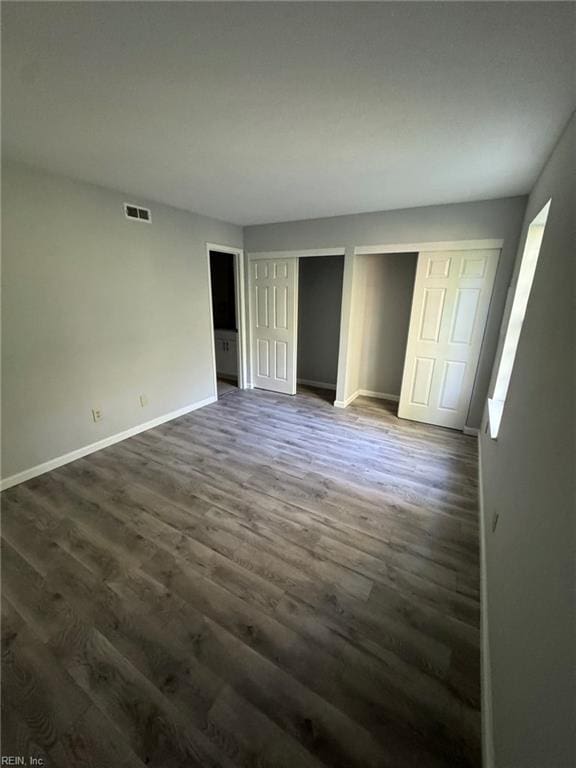 unfurnished bedroom featuring dark wood-type flooring