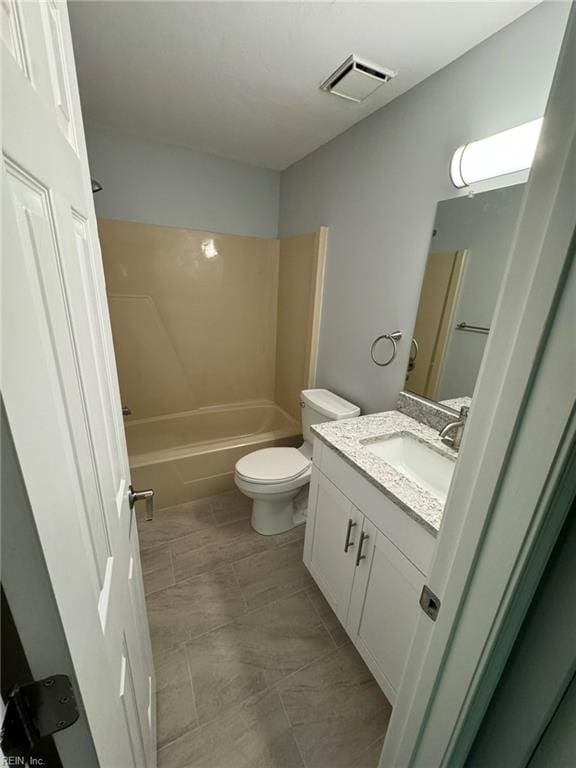 full bathroom with washtub / shower combination, vanity, and toilet