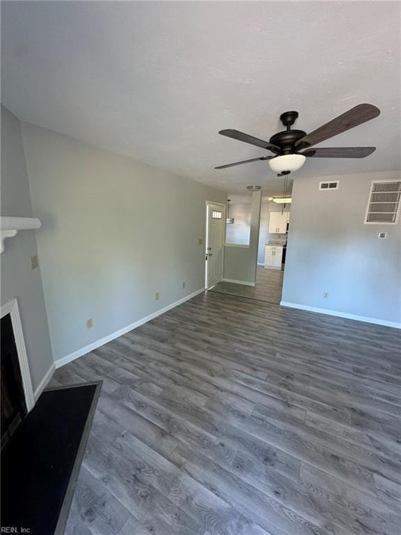 unfurnished living room with hardwood / wood-style flooring and ceiling fan