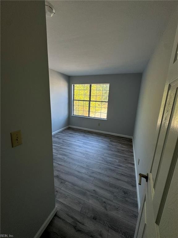 unfurnished room with dark hardwood / wood-style floors