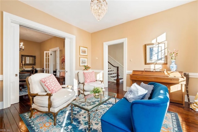 sitting room with dark hardwood / wood-style floors and a chandelier