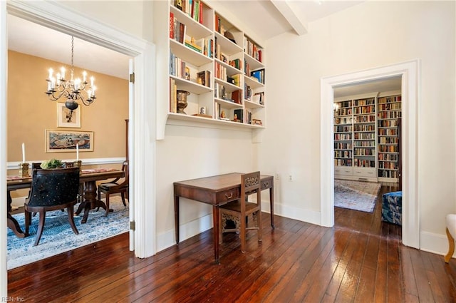 interior space featuring dark wood-type flooring, a chandelier, and built in features