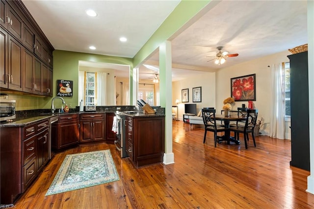 kitchen featuring hardwood / wood-style flooring, a healthy amount of sunlight, sink, and kitchen peninsula