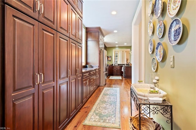 corridor with light hardwood / wood-style floors