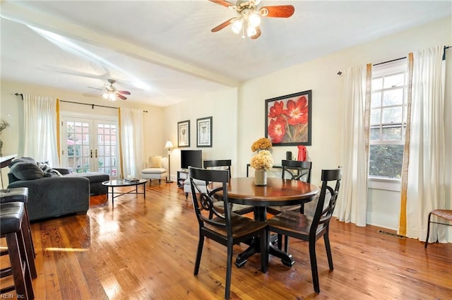 dining area with ceiling fan, wood-type flooring, a healthy amount of sunlight, and french doors