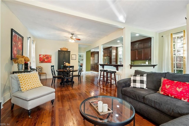 living room featuring hardwood / wood-style flooring and ceiling fan