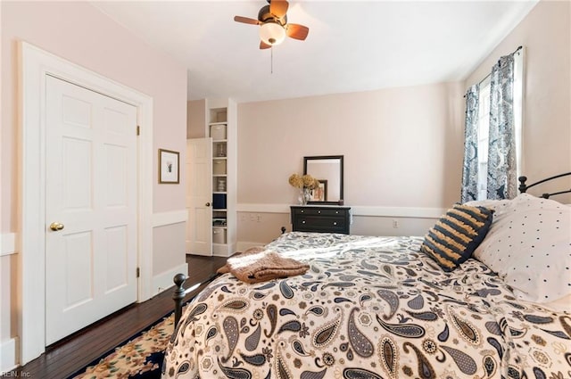 bedroom featuring dark hardwood / wood-style flooring, a closet, and ceiling fan