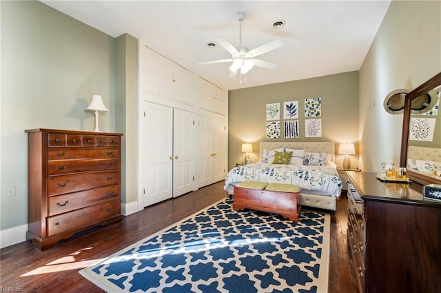 bedroom with ceiling fan, dark hardwood / wood-style floors, and a closet