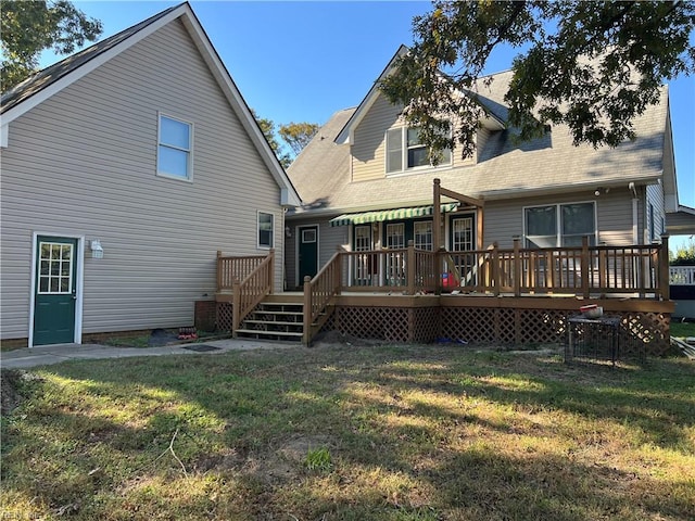 back of property with a lawn and a deck