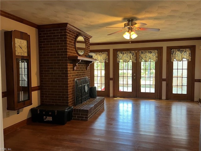 unfurnished living room with a fireplace, hardwood / wood-style flooring, ceiling fan, and ornamental molding