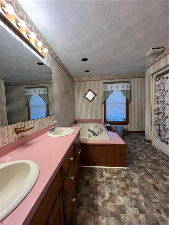 bathroom with vanity and separate shower and tub