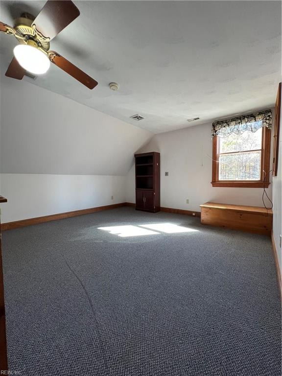 bonus room featuring lofted ceiling, carpet, and ceiling fan