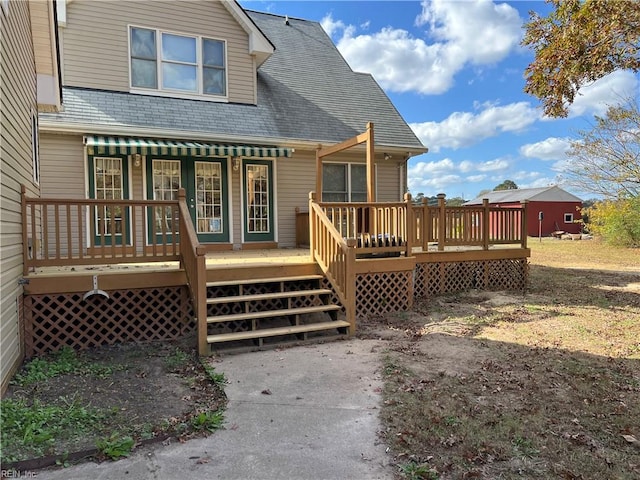 rear view of property featuring a wooden deck