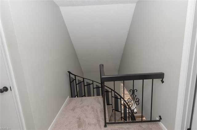 stairs featuring lofted ceiling and carpet floors