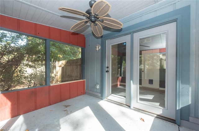 unfurnished sunroom with ceiling fan