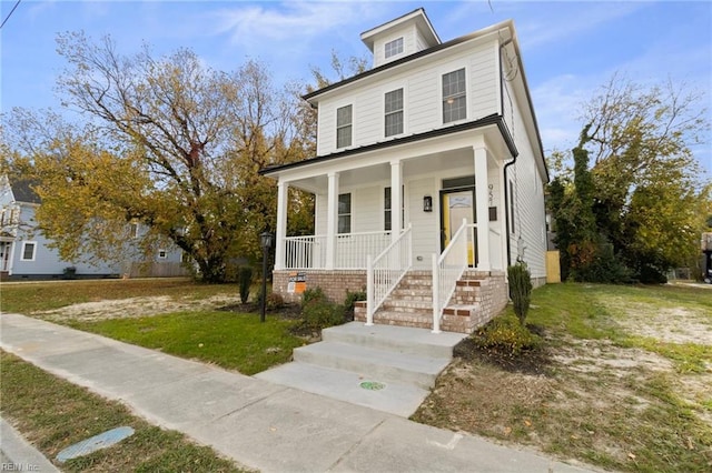 view of front of home featuring a front yard and covered porch