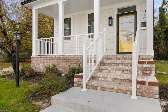 view of exterior entry with a porch