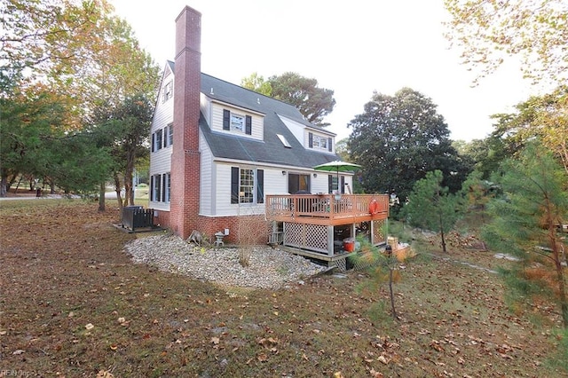 rear view of house with central air condition unit and a deck