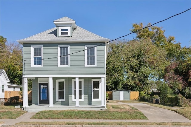 view of front of property with covered porch and a storage unit