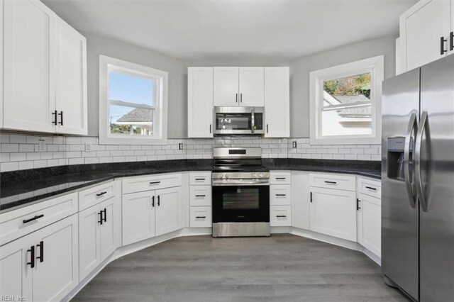 318 Sycamore Ave, Newport News, VA 23607 - kitchen with stainless steel appliances, white cabinetry, and plenty of natural light
