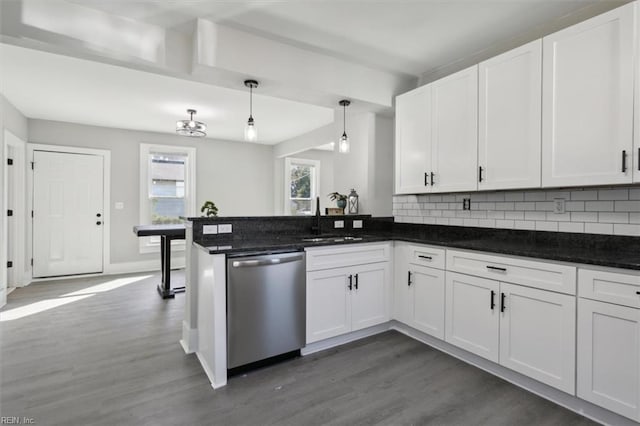 kitchen with sink, kitchen peninsula, white cabinets, pendant lighting, and dishwasher