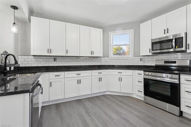 318 Sycamore Ave, Newport News, VA 23607 - kitchen featuring appliances with stainless steel finishes, a sink, white cabinetry, and decorative backsplash