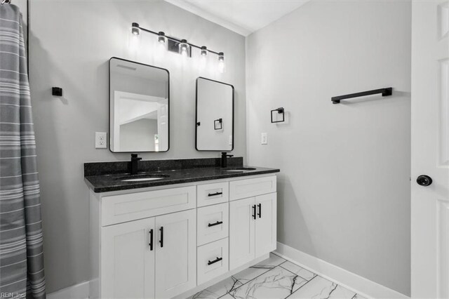 318 Sycamore Ave, Newport News, VA 23607 - bathroom with baseboards, marble look tile flooring, and double vanity