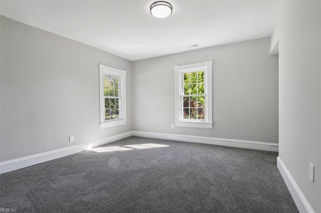 empty room featuring dark colored carpet