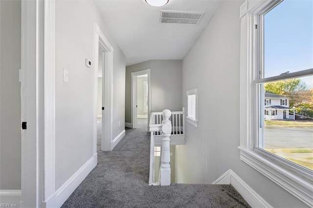 hallway with dark colored carpet