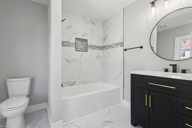 full bathroom with vanity, tiled shower / bath combo, and toilet