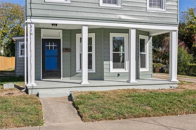 view of exterior entry featuring a porch