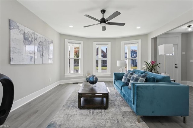 living room featuring hardwood / wood-style floors and ceiling fan