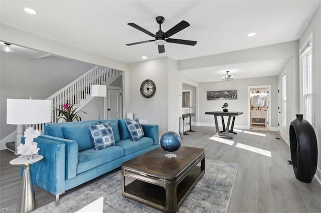 living room with wood-type flooring and ceiling fan