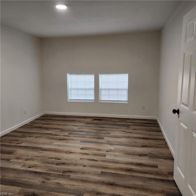 unfurnished room with dark hardwood / wood-style flooring