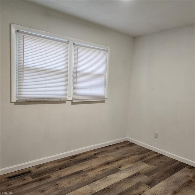 spare room featuring dark hardwood / wood-style floors