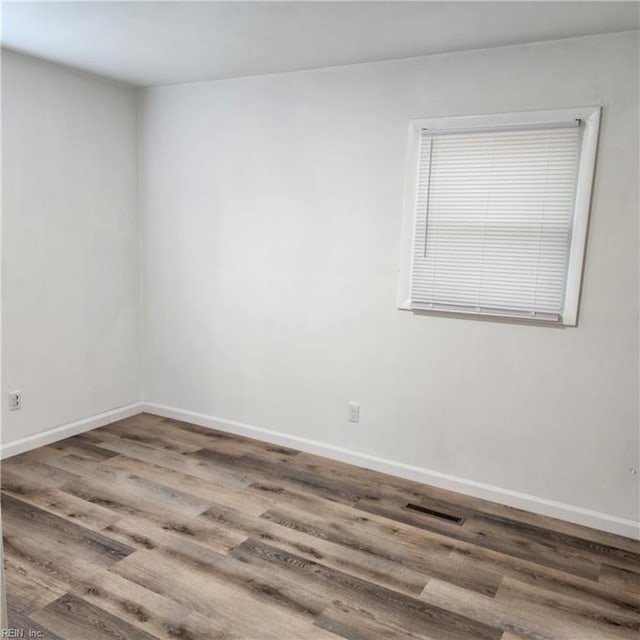 empty room with hardwood / wood-style floors