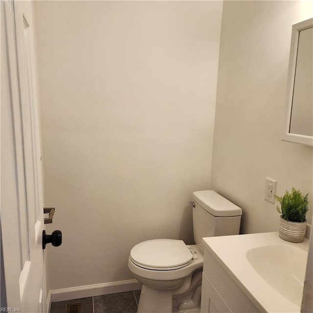 bathroom with tile patterned floors, vanity, and toilet