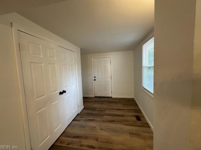 hallway with dark hardwood / wood-style floors