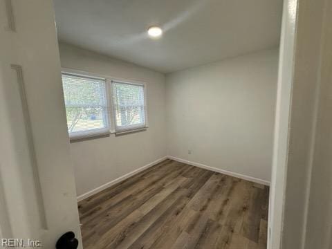 empty room with dark wood-type flooring