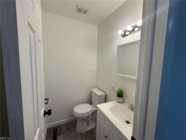 bathroom with tile patterned flooring, vanity, and toilet