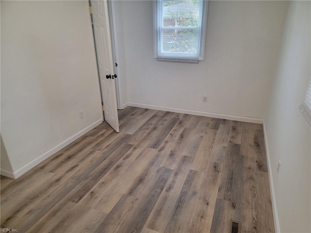 spare room featuring hardwood / wood-style flooring