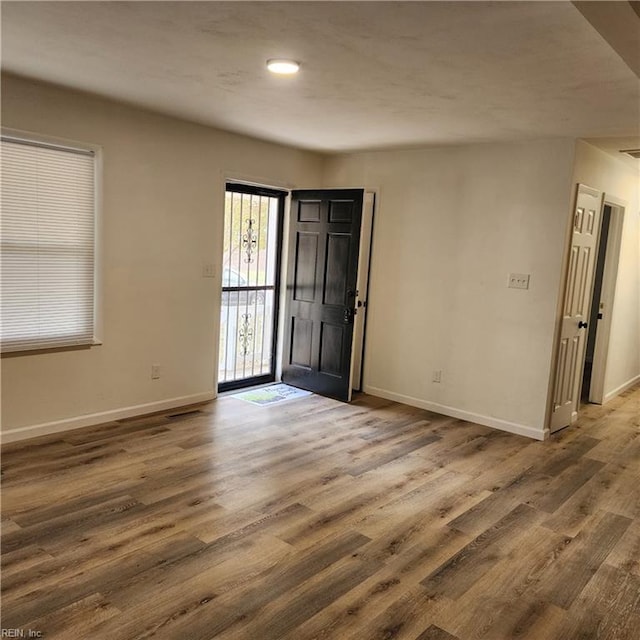 spare room with dark hardwood / wood-style flooring