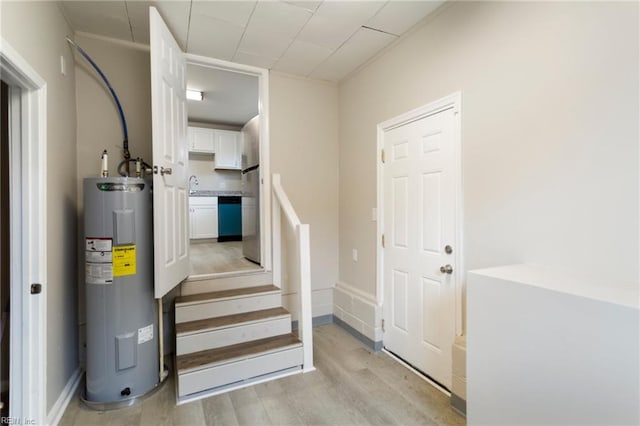 utility room featuring sink and electric water heater