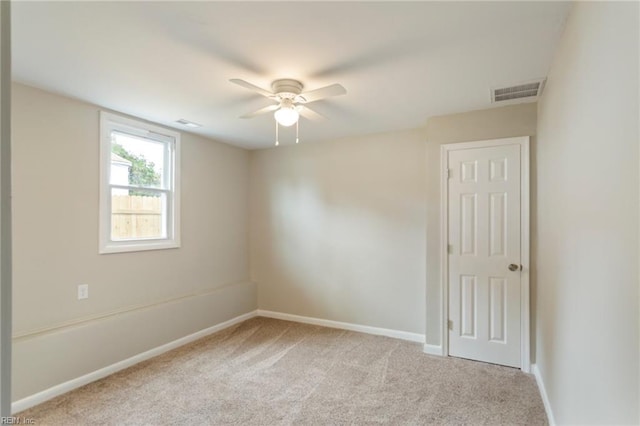 empty room with light colored carpet and ceiling fan