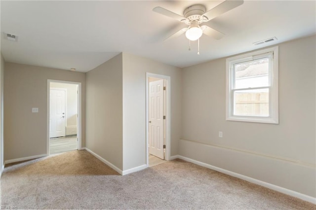 unfurnished bedroom featuring ceiling fan and light carpet